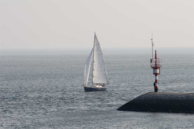 Een bootje komt de haven van West-Terschelling binnen